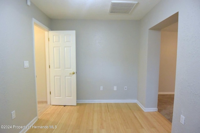 unfurnished room with light wood-type flooring