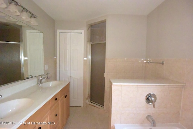 bathroom featuring vanity, tile patterned flooring, and plus walk in shower