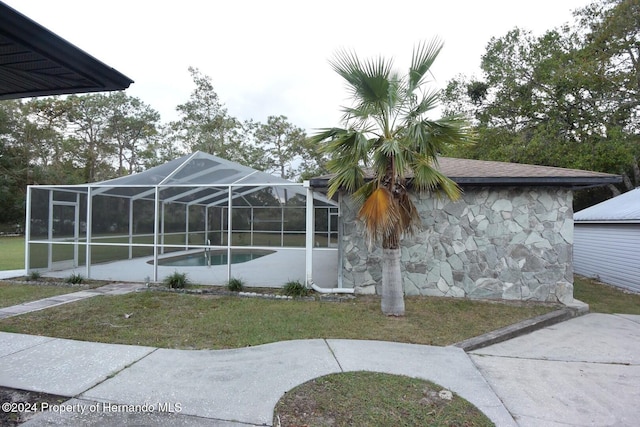 exterior space with a yard and a swimming pool