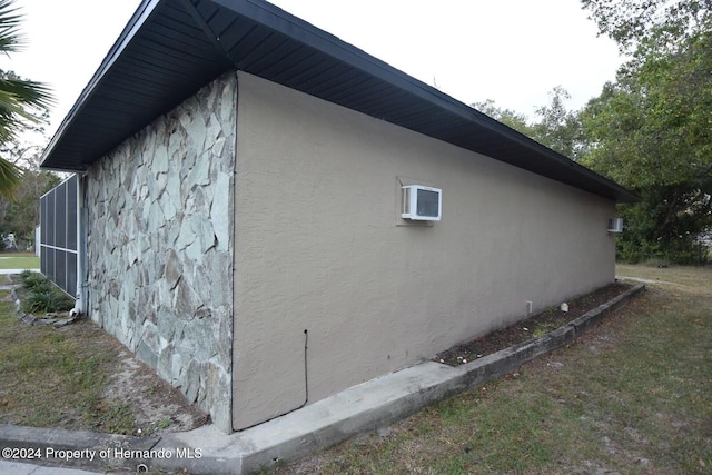 view of home's exterior with an AC wall unit