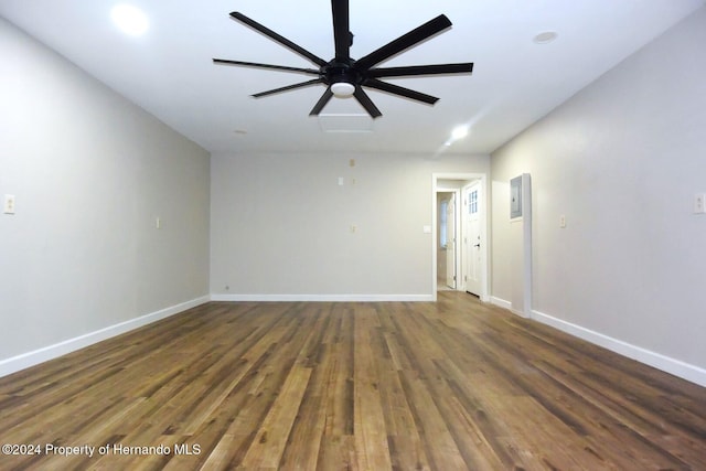 spare room with dark hardwood / wood-style floors and ceiling fan