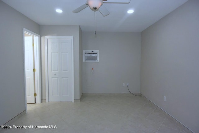 empty room with an AC wall unit and ceiling fan