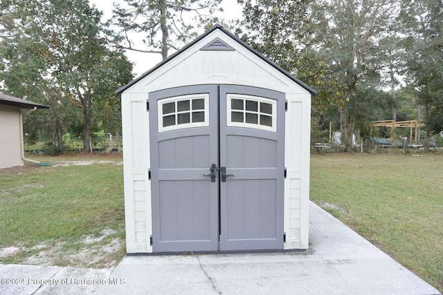 view of outbuilding with a lawn