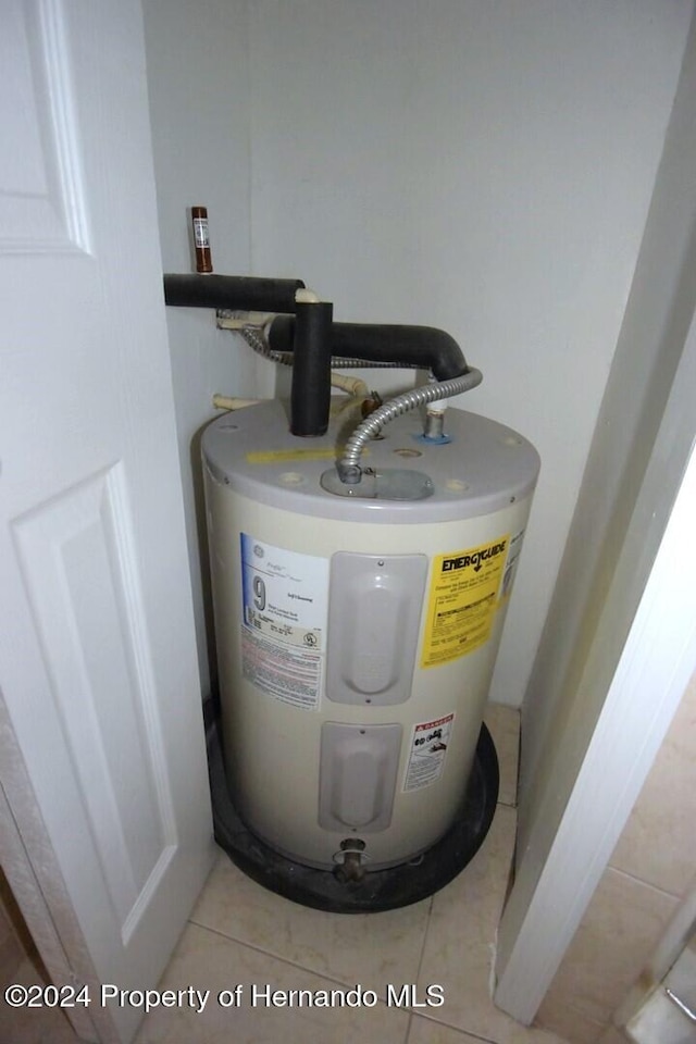 utility room featuring water heater