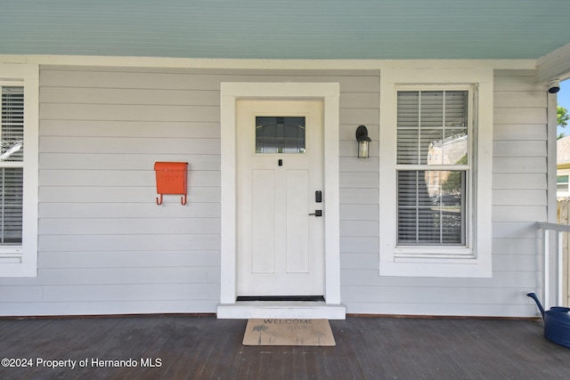 view of exterior entry featuring a porch