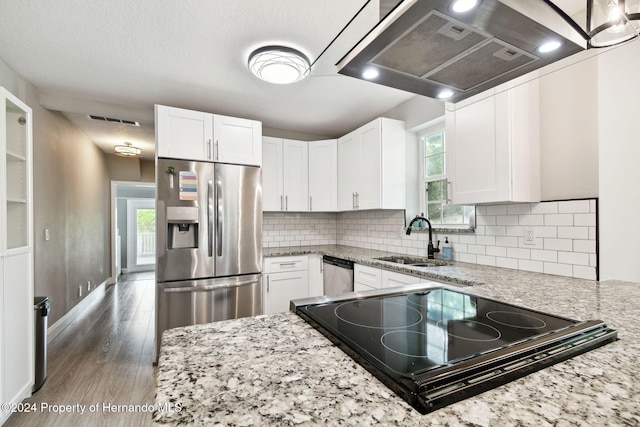 kitchen featuring light stone countertops, appliances with stainless steel finishes, white cabinetry, and sink