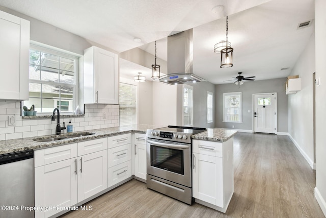 kitchen with sink, stainless steel appliances, kitchen peninsula, island range hood, and white cabinets