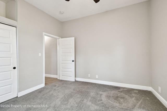 unfurnished bedroom featuring ceiling fan and carpet