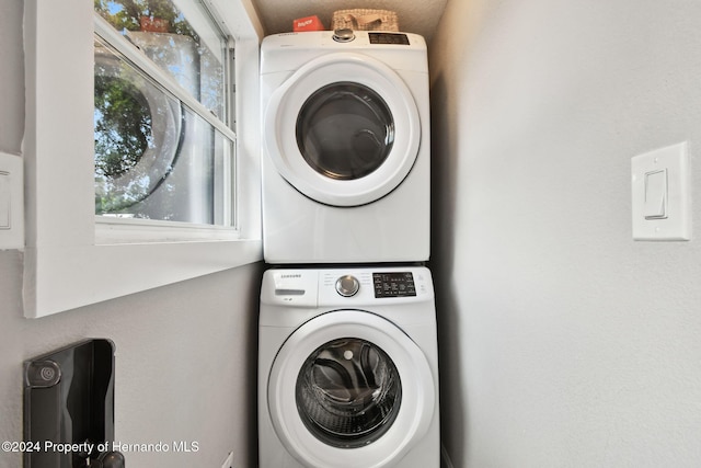 laundry area featuring stacked washing maching and dryer