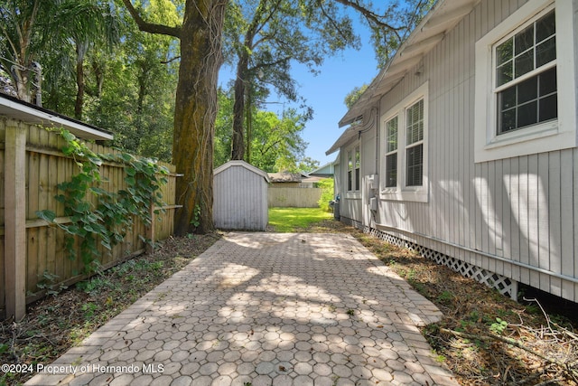 view of patio with a storage shed