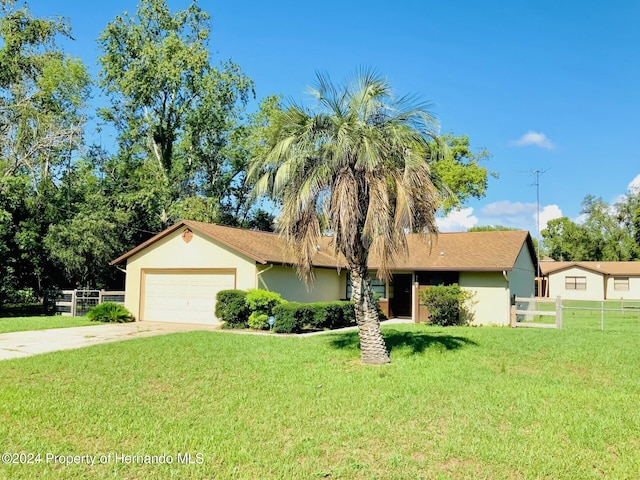 single story home featuring a garage and a front lawn