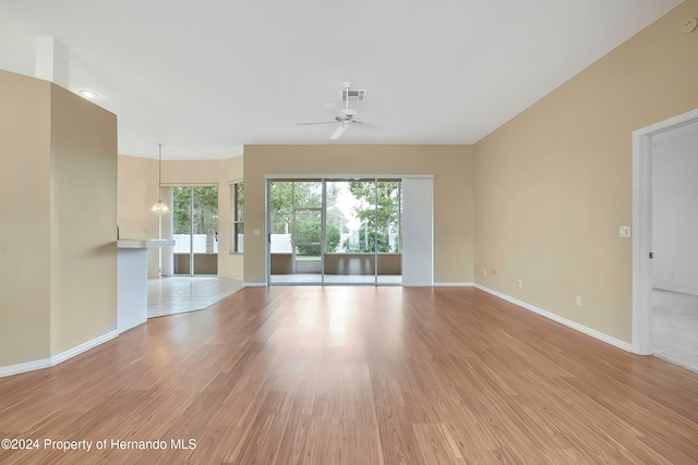 unfurnished living room with light hardwood / wood-style floors and ceiling fan with notable chandelier