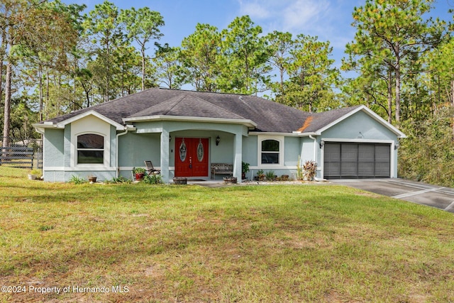 ranch-style home featuring a garage and a front lawn