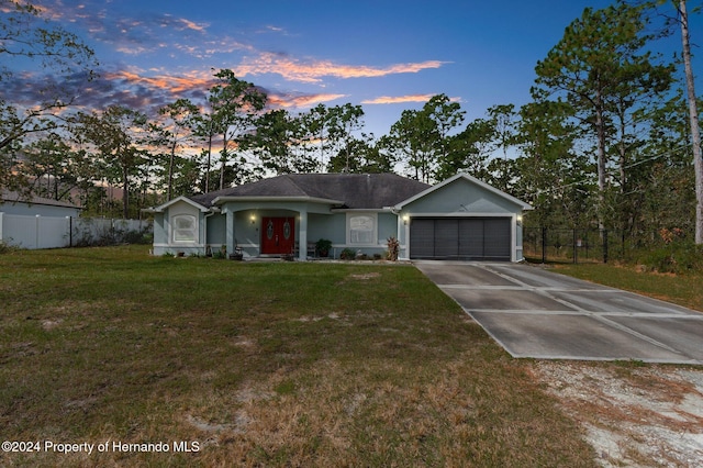 ranch-style home with a lawn and a garage