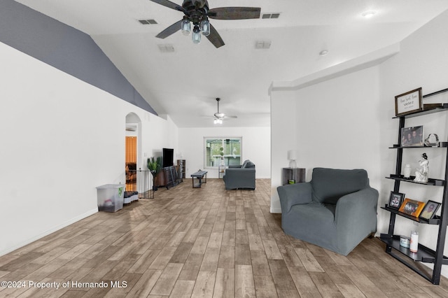 living room featuring light hardwood / wood-style floors, ceiling fan, and lofted ceiling