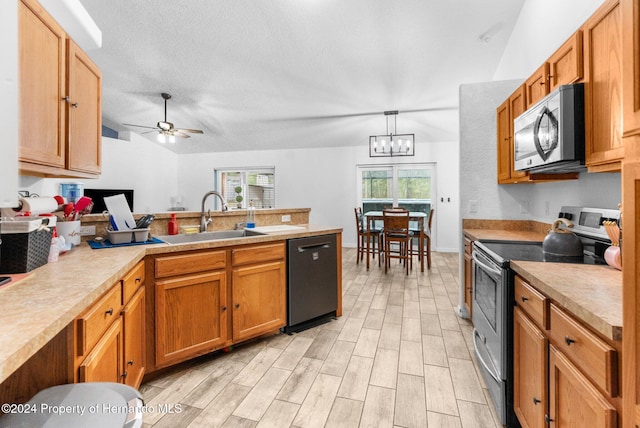 kitchen featuring ceiling fan with notable chandelier, stainless steel appliances, sink, light wood-type flooring, and decorative light fixtures