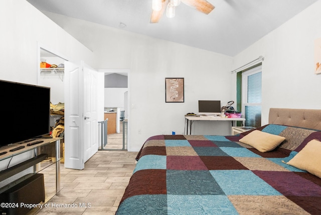 bedroom featuring ceiling fan, a closet, light wood-type flooring, and lofted ceiling