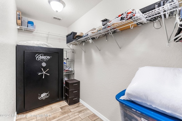 walk in closet featuring light hardwood / wood-style flooring