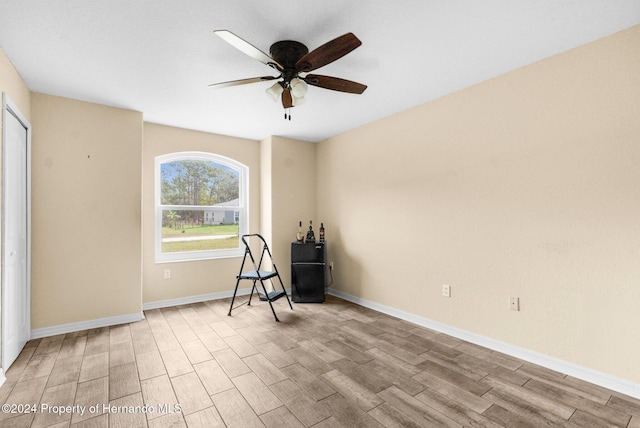 unfurnished room featuring light wood-type flooring and ceiling fan