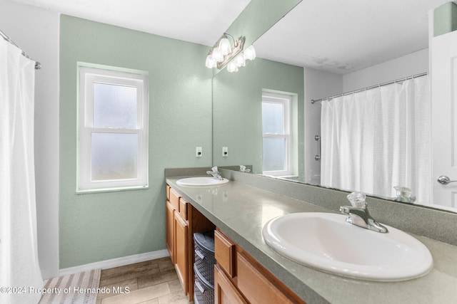 bathroom with hardwood / wood-style floors, vanity, and a shower with curtain