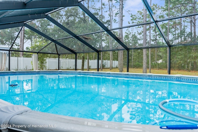 view of swimming pool with a lanai