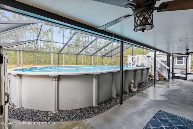 view of swimming pool with a patio area, a lanai, and ceiling fan