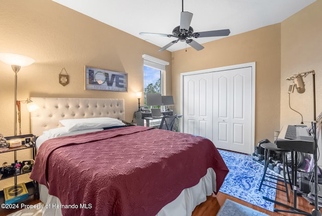 bedroom featuring wood-type flooring, a closet, and ceiling fan