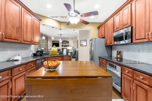 kitchen with decorative light fixtures, ceiling fan, appliances with stainless steel finishes, and tasteful backsplash