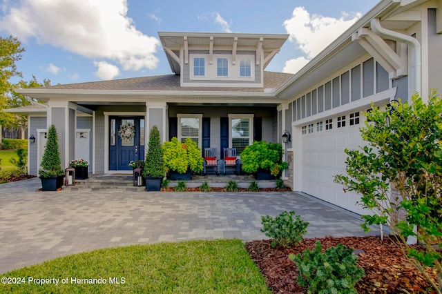 view of front of home featuring a garage and covered porch