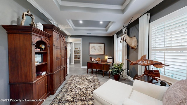 office space featuring plenty of natural light, a raised ceiling, and crown molding