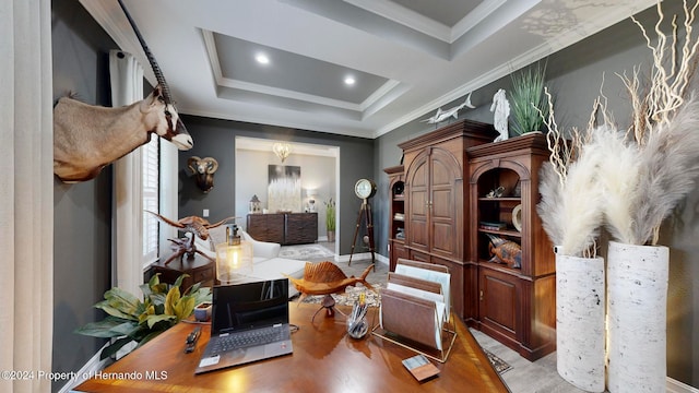 office featuring light wood-type flooring, a tray ceiling, and ornamental molding