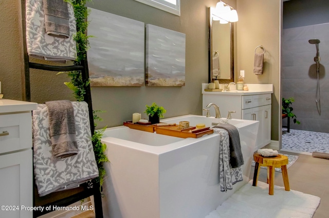 bathroom with vanity and a tile shower