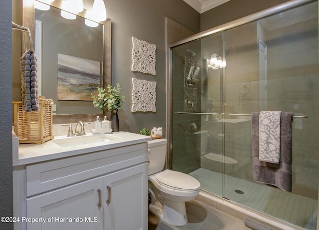 bathroom featuring a shower with door, crown molding, vanity, tile patterned flooring, and toilet