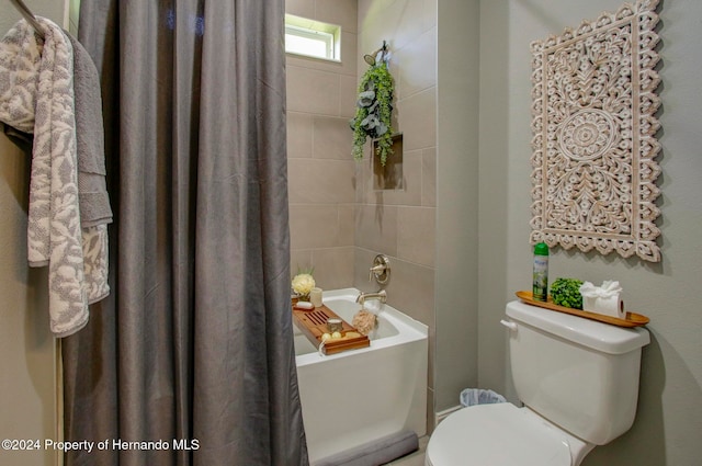 bathroom featuring toilet and shower / bath combination with curtain