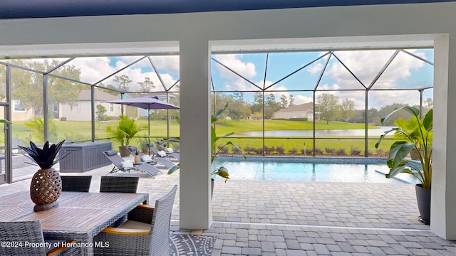 exterior space featuring a lanai and a water view