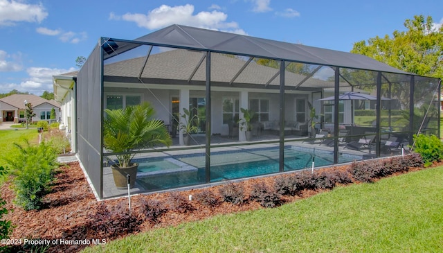 back of property with a lawn, a lanai, and a patio area