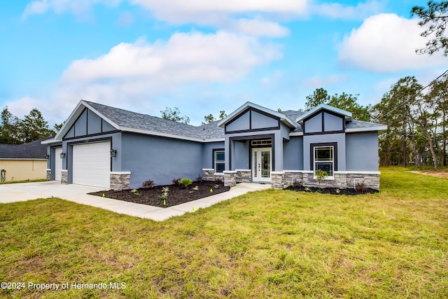 view of front of house featuring a garage and a front lawn