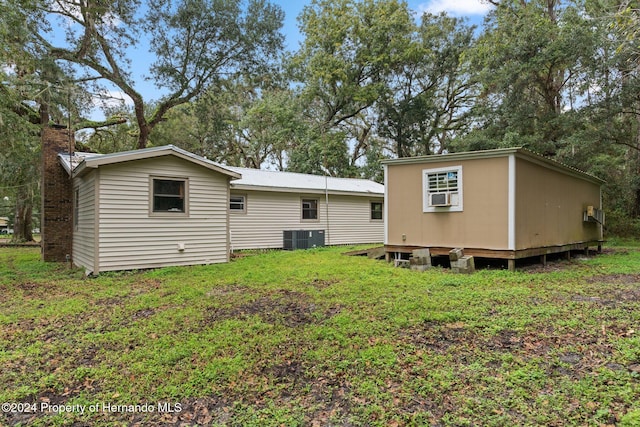 rear view of property featuring a lawn