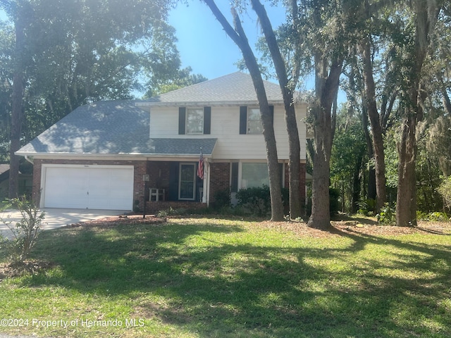 front of property featuring a front yard and a garage