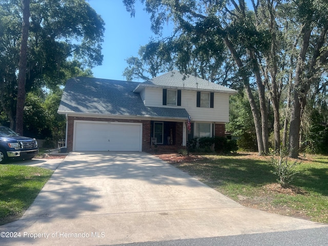 front facade featuring a garage and a front yard