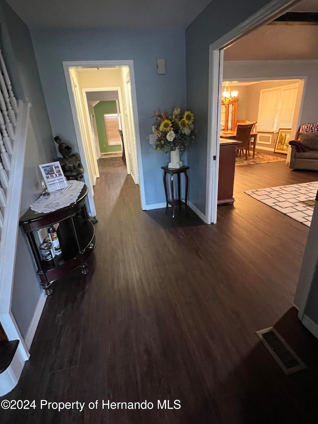 hallway featuring dark hardwood / wood-style flooring