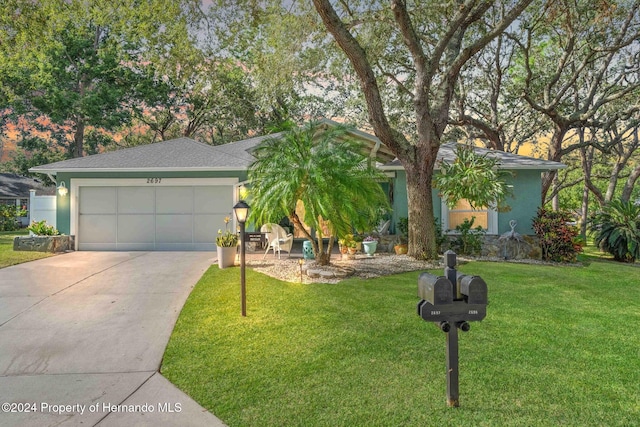 view of front of property with a front lawn and a garage