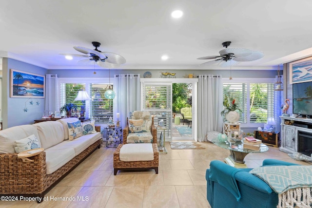 living room featuring a wealth of natural light, light tile patterned floors, and ceiling fan