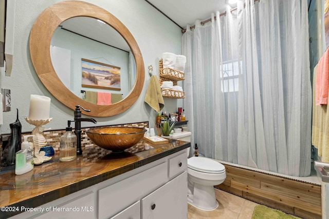 full bathroom featuring vanity, tile patterned floors, toilet, and shower / tub combo