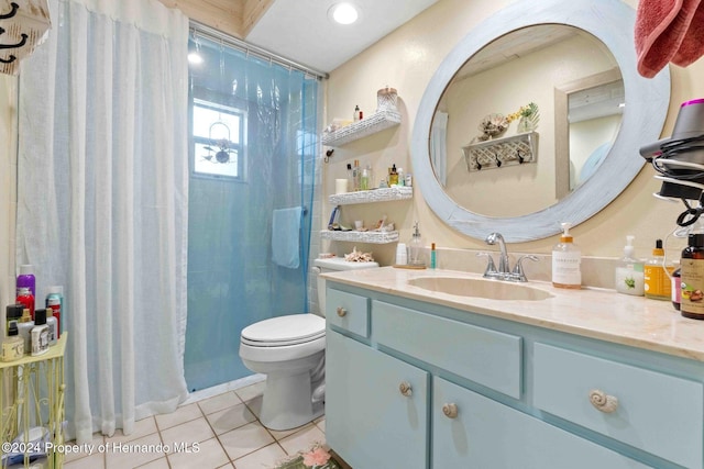 bathroom with toilet, vanity, tile patterned floors, and a shower with shower curtain