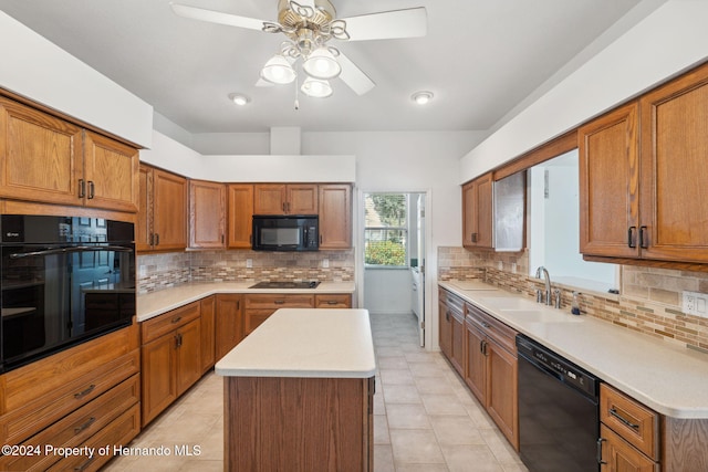 kitchen featuring black appliances, sink, decorative backsplash, ceiling fan, and a kitchen island