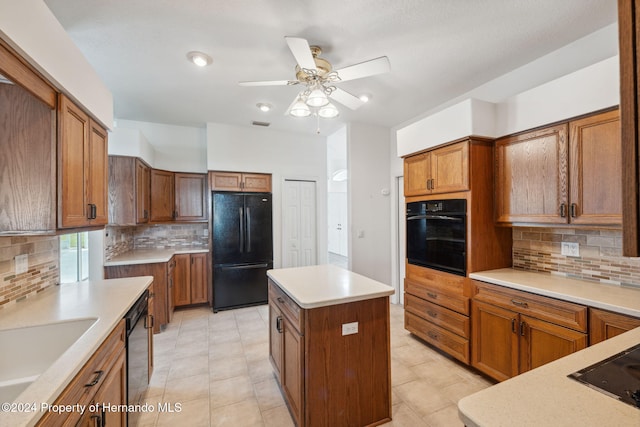 kitchen with ceiling fan, a center island, sink, decorative backsplash, and black appliances