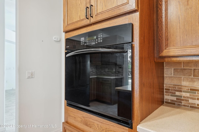 details featuring tasteful backsplash and double oven