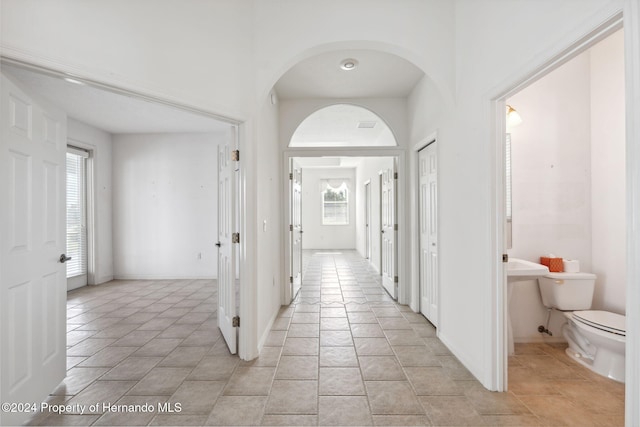 hallway featuring light tile patterned floors