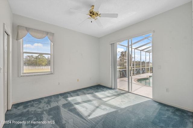 carpeted empty room with ceiling fan